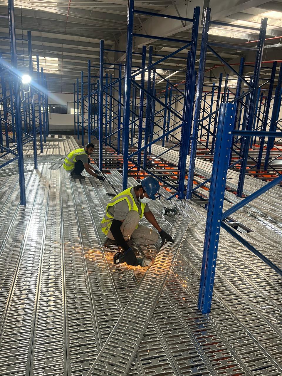 Technicians fitting racking floor decking on site